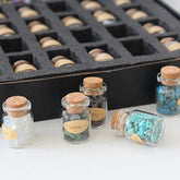 Set of 55 natural gemstone crystal bottles from TEMU, featuring colorful, polished mineral specimens in small glass bottles.
