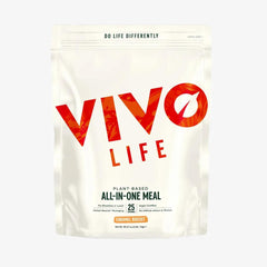 Vivo Life Whole Plant-Based Nutritional Shake supplement in a glass with a scoop of powder and fresh ingredients.