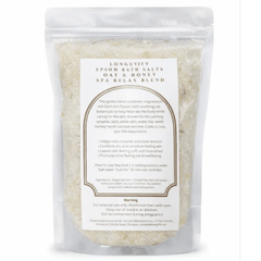 Green and white packaging of AW GIFTS Longevity Oat & Honey Epsom Bath Salt Spa Relax Blend with natural ingredients and relaxing spa theme.