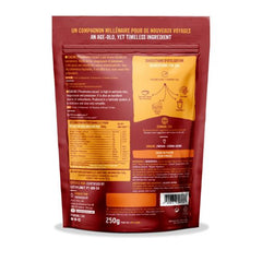 Iswari BIO cacao powder in a 250g package, gluten-free supplement, shown in a natural setting with cacao beans.