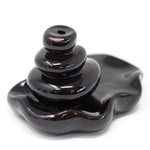 Large back flow incense burner by AW GIFTS featuring pebbles pouring into a pool, creating a calming visual effect.