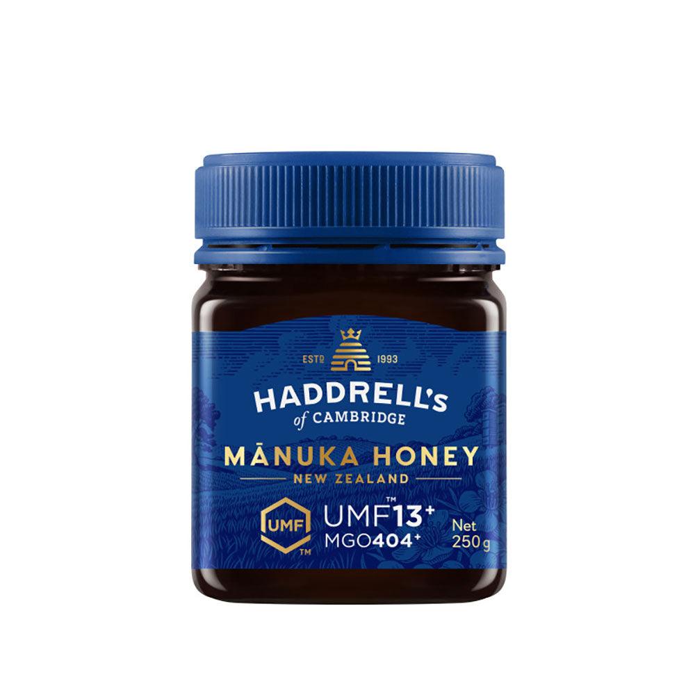 Herbalistas Haddrells Manuka Honey UMF13+ MGO404+ in a 250g jar, showcasing the golden, thick honey with a smooth texture.
