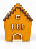Velarte Little Haven handmade house candle in golden amber, showcasing a warm, decorative candle design.
