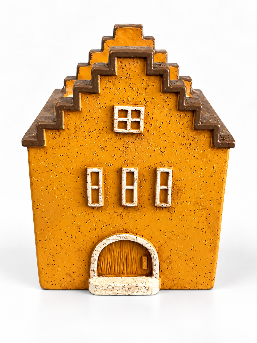Velarte Little Haven handmade house candle in golden amber, showcasing a warm, decorative candle design.