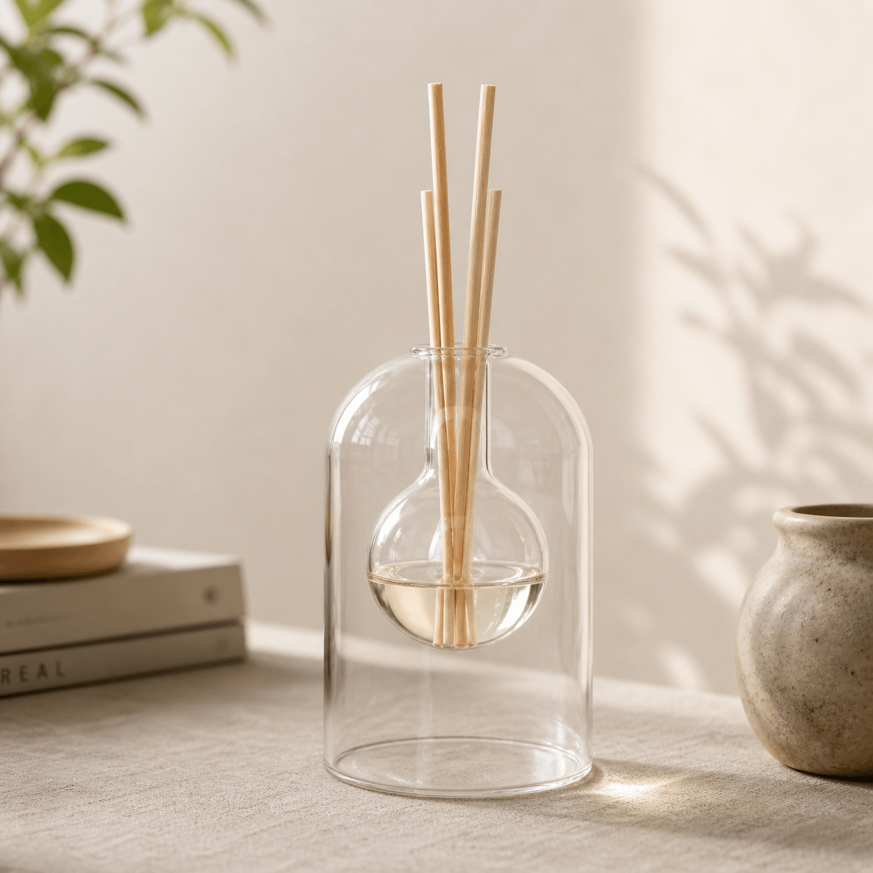 Clear modern floral aroma diffuser bottle made of minimalist glass, designed for elegant fragrance display.
