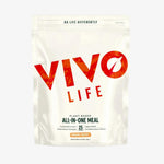 Vivo Life Whole Plant-Based Nutritional Shake supplement in a glass with a scoop of powder and fresh ingredients.