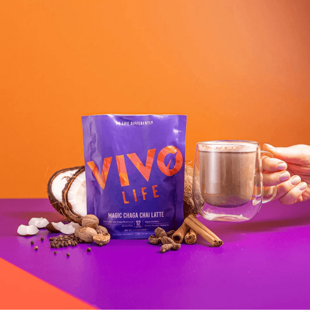 Vivo Life Magic Chaga Chai Latte supplement package featuring a colorful label and a steaming chai latte in a mug.