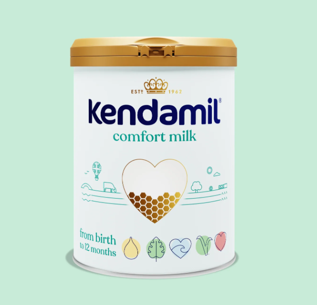 Kendamil Comfort Milk formula in a container with a scoop, designed for infants, by PETROUTSIOS.