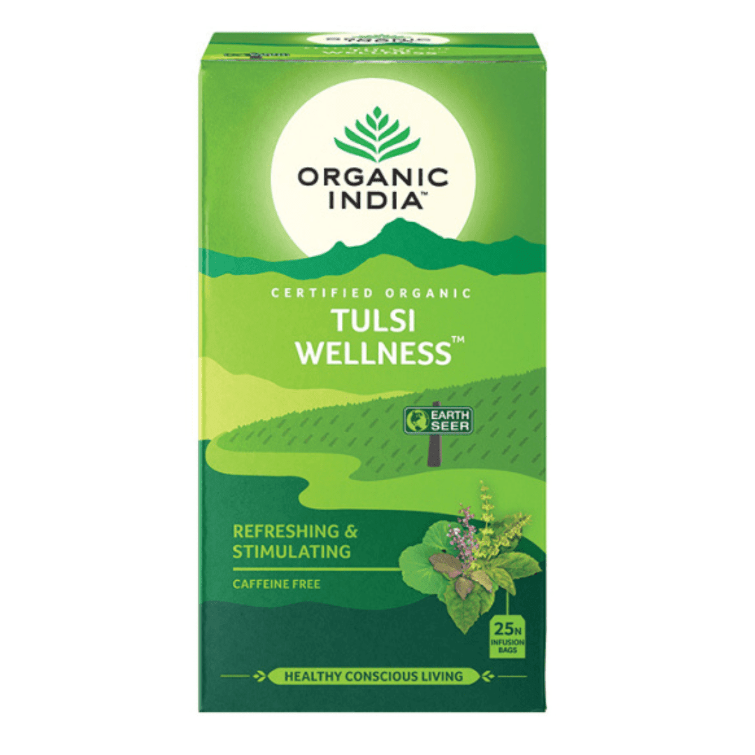Organic India BIO Tulsi Wellness Tea in caffeine-free infusion bags, showcasing the tea packaging and fresh herbal leaves.