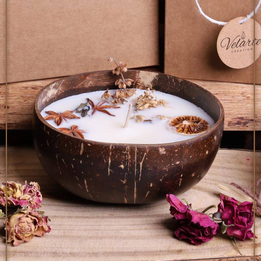 Soy wax candle in a coconut bowl by Velarte, featuring a natural, handcrafted design with a soft, inviting glow.