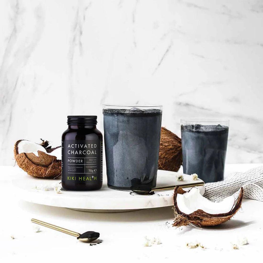 Herbalistas Kiki Health activated charcoal powder in a 70g container, showing the black powder inside.