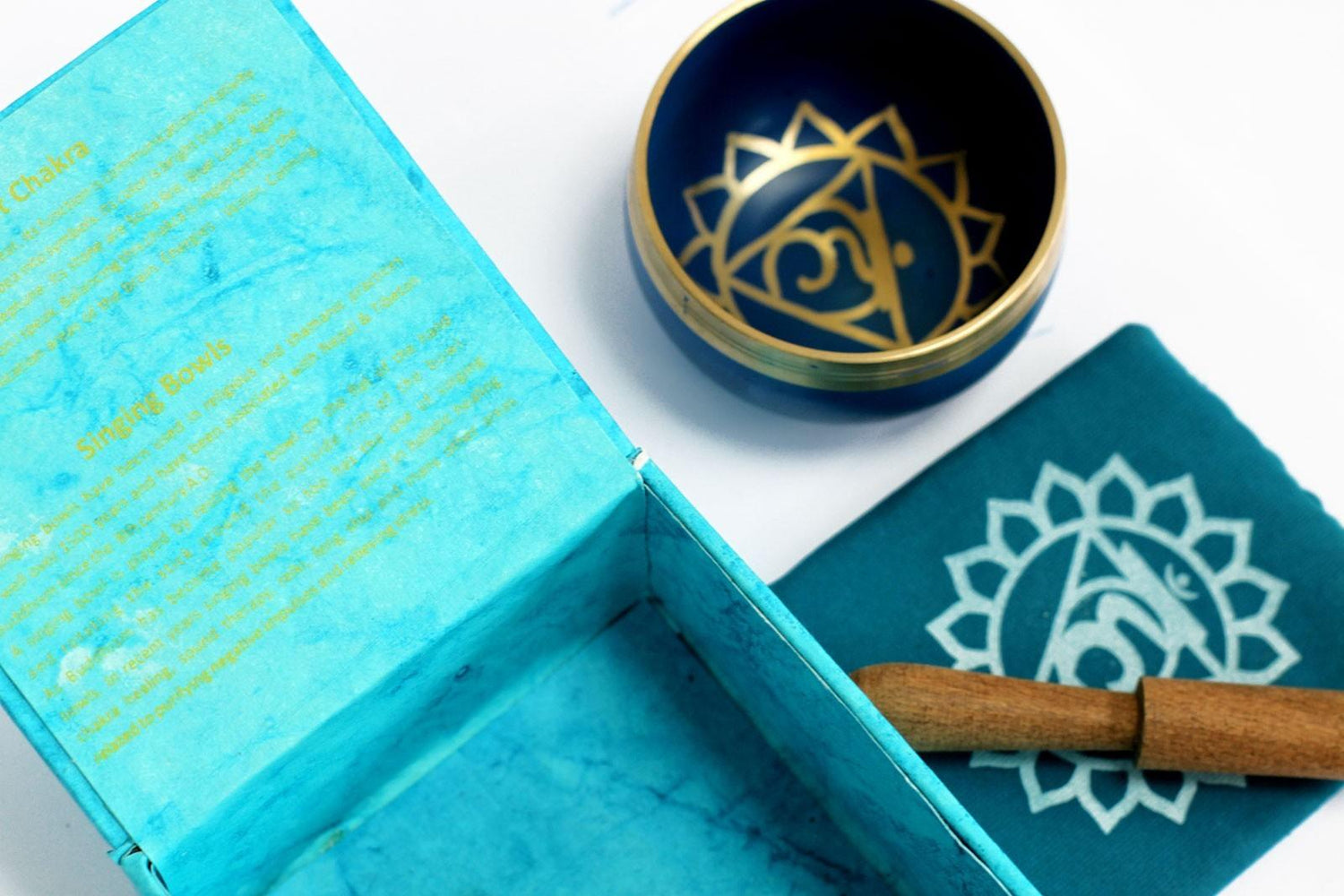 AW Gifts Chakra Singing Bowl Throat accessory, handcrafted metal bowl for meditation and sound therapy, displayed on a wooden surface.