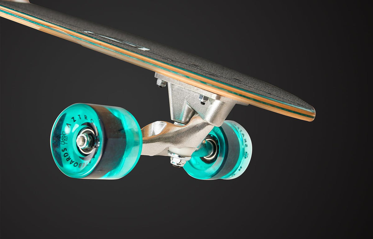 Viking Fitness Forest 34-inch surfskate skateboard with a natural wood finish and colorful grip tape, designed for smooth riding and tricks.