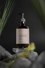Selfnamed Patchouli & Amber Vanilla Hand & Body Wash bottle with a sleek design and natural fragrance display.