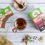 Organic India BIO Tulsi Masala Chai Tea bags with aromatic spices and herbs, displayed in a natural setting.