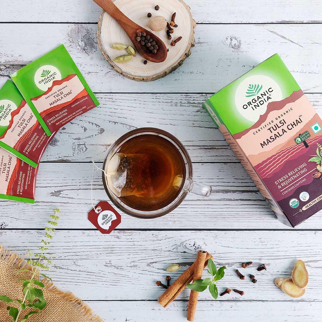 Organic India BIO Tulsi Masala Chai Tea bags with aromatic spices and herbs, displayed in a natural setting.