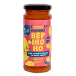 Pella's Delicacies Apricot Spread jar with a spoon, displaying smooth apricot fruit spread on a white background.